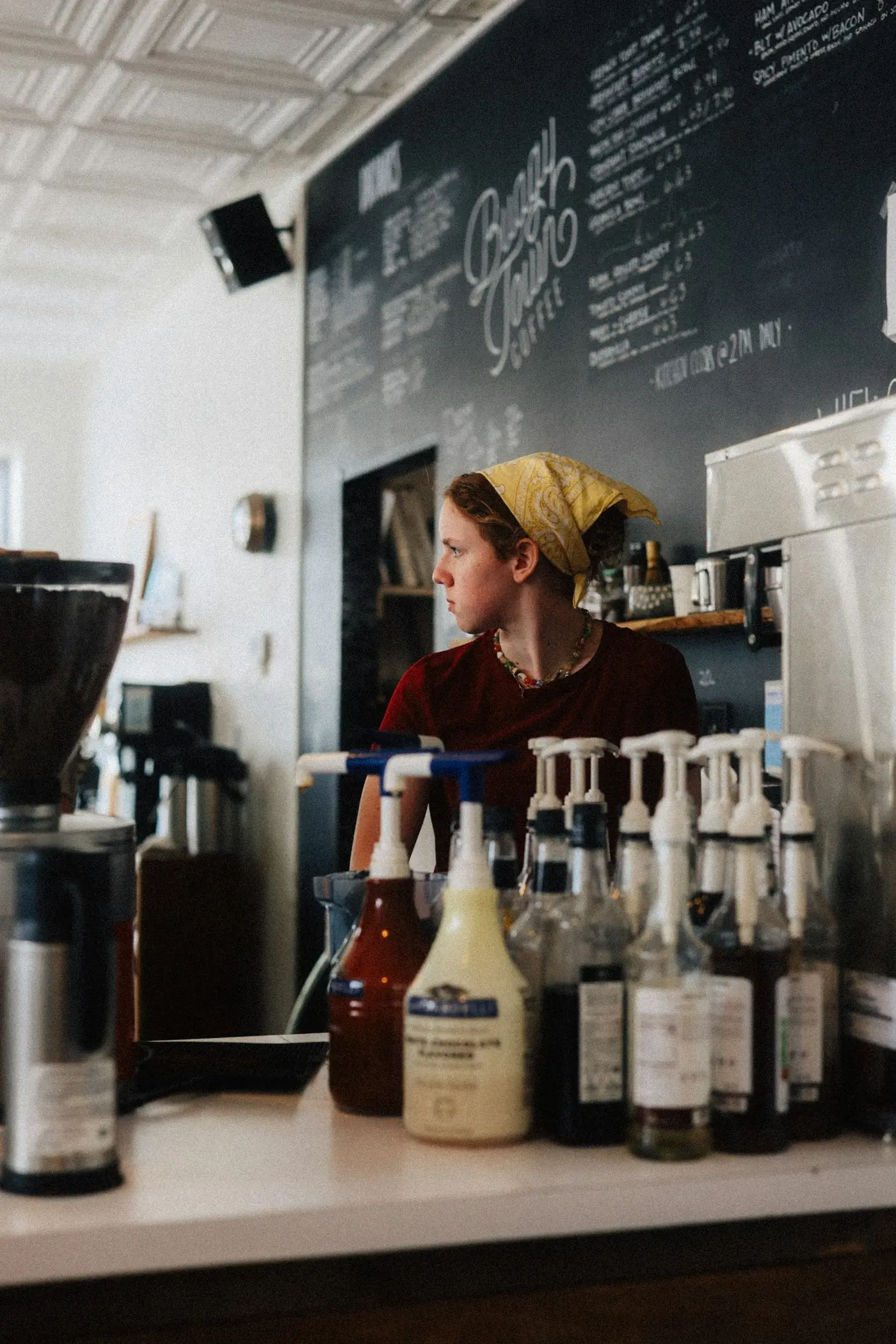A barista working behind the counter of a coffee shop